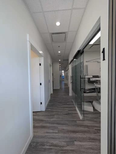 Calm hallway leading to private treatment rooms at Rundlehorn Smiles Dental in NE Calgary